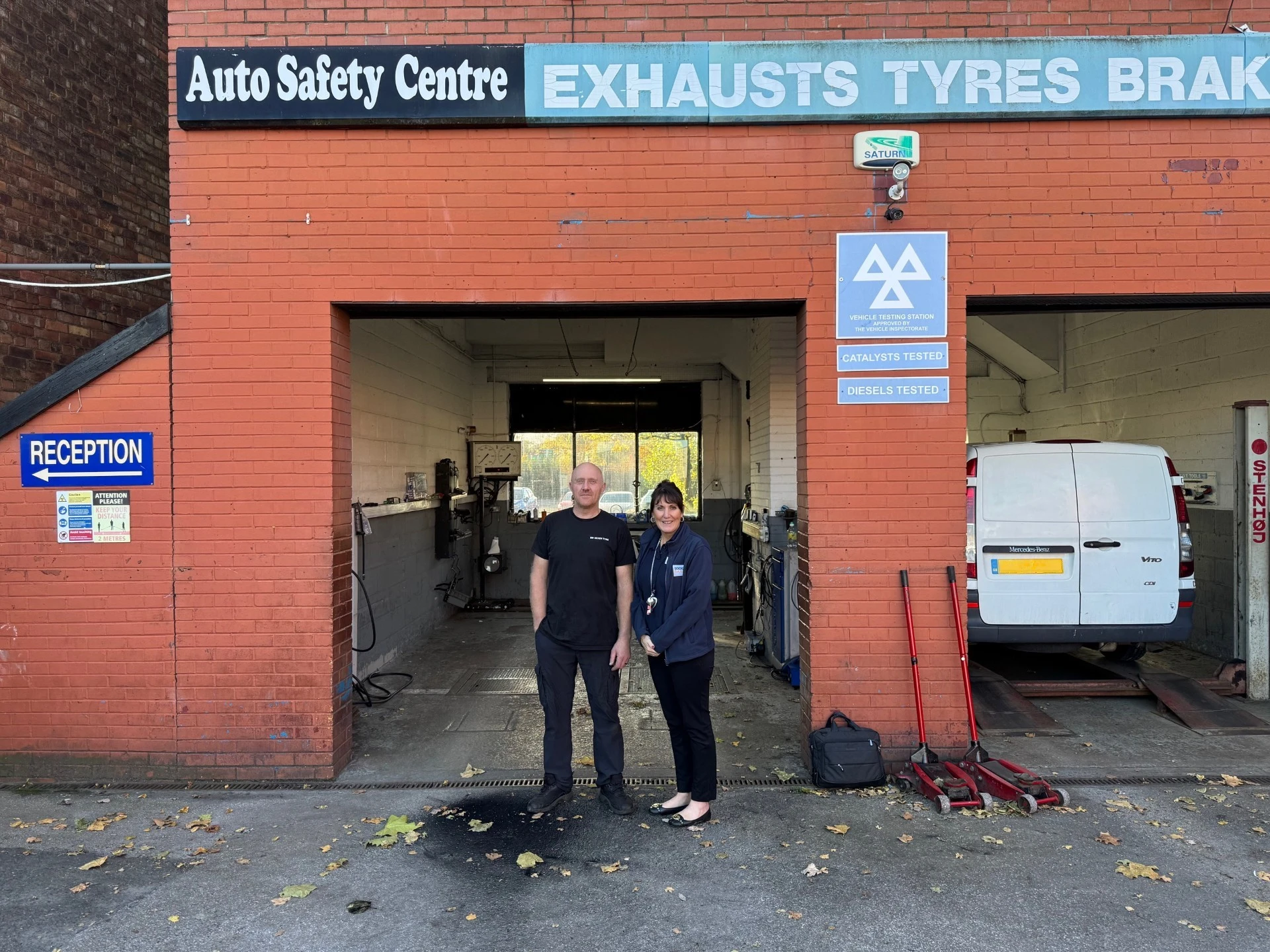 BookMyGarage employee stood in front of AutoSafetyCentre Saint Helens with garage owner